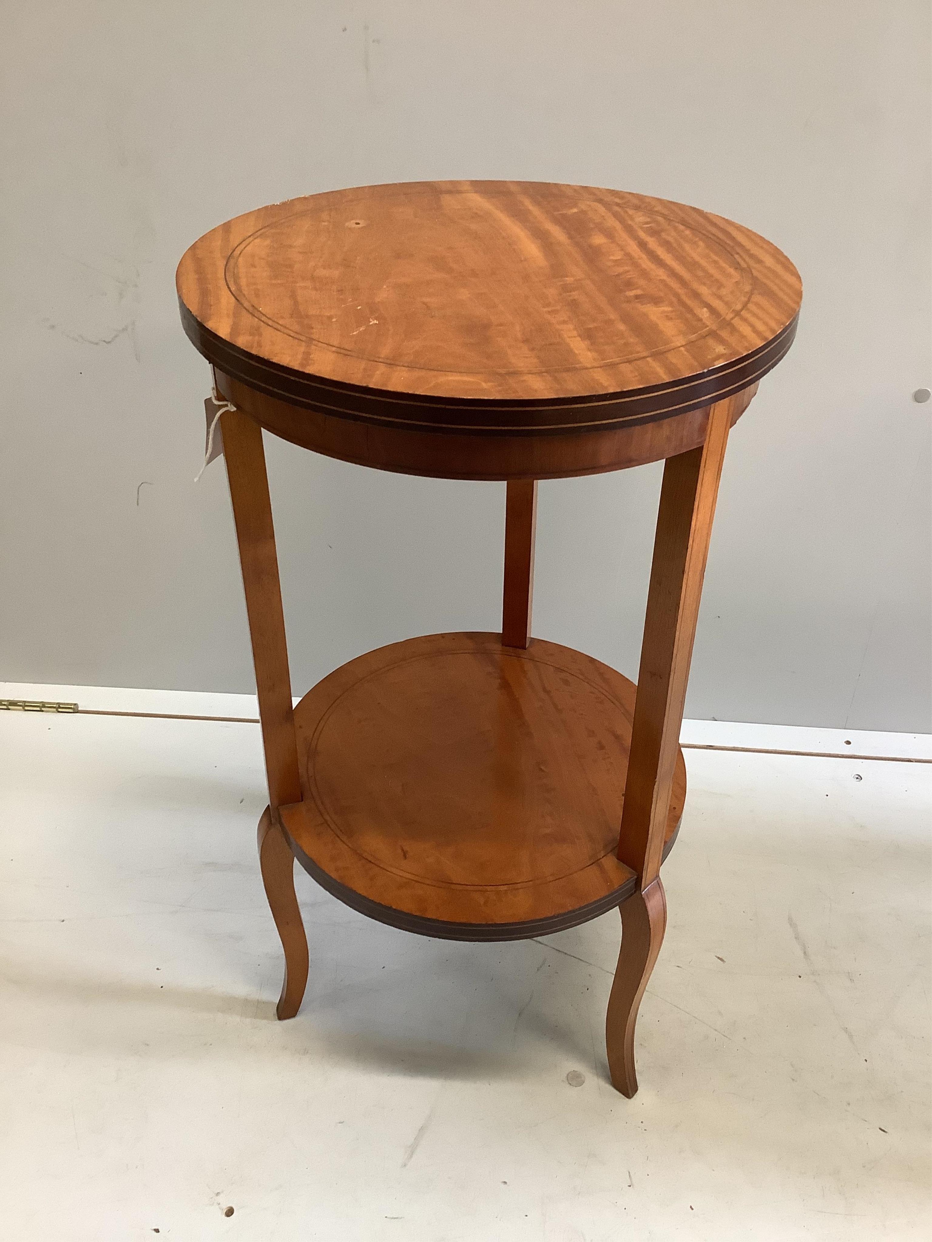 An Edwardian circular satinwood two tier occasional table, diameter 38cm, height 70cm. Condition - fair
